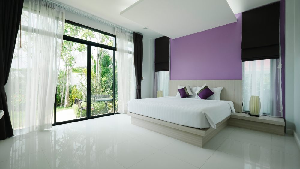 Modern hotel bedroom with glossy flooring