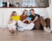 Happy family sitting on the laminate floor in the kitchen